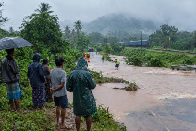 Rainy Tropical Road Flooding with Rescue Workers
