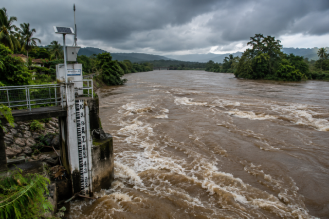 Turbulent River Flood Beneath Storm Clouds